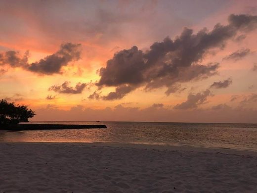 Sunset over a quiet beach in the Maldives