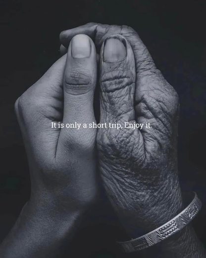 Two hands, one young and one old, clasped together